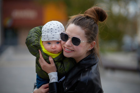 Young mother with her baby in the city. Portrait of a mother and her babyの写真素材