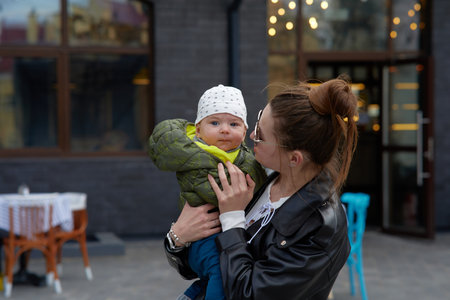 mother and baby in the city. A young woman with a baby in her arms.の写真素材