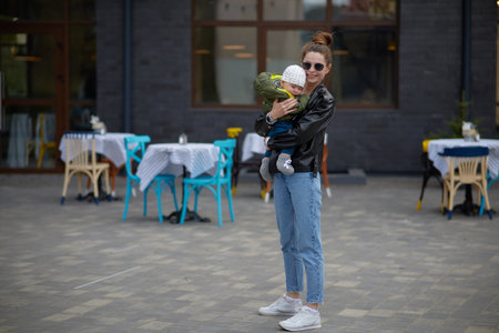 Young mother with her little son walking in the city. motherhood.の写真素材