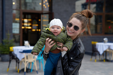 Portrait of a mother with her baby boy in the city.の写真素材