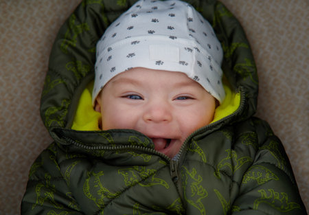 Portrait of a cute newborn baby boy in a sleeping bag.の写真素材