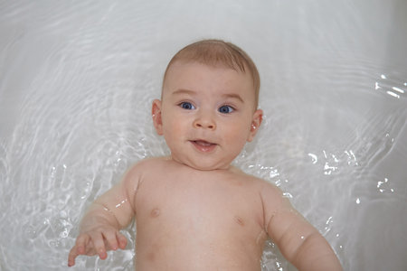 Cute baby boy in the tub. Shallow depth of field.の写真素材
