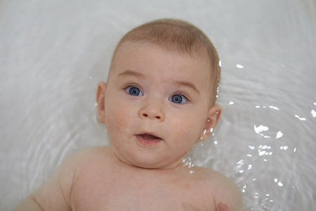 Portrait of cute baby boy in bathtub. Shallow depth of fieldの写真素材