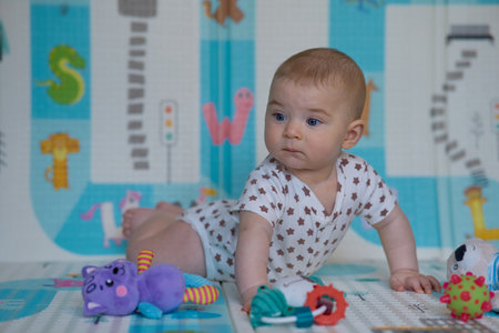 portrait of a cute little baby girl playing with toys on the floorの写真素材
