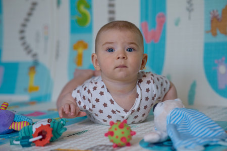 Cute little baby girl playing with toys on the floor at homeの写真素材