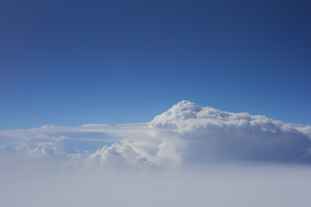 Cloudscape, view from airplane window, blue sky and white clouds.の写真素材