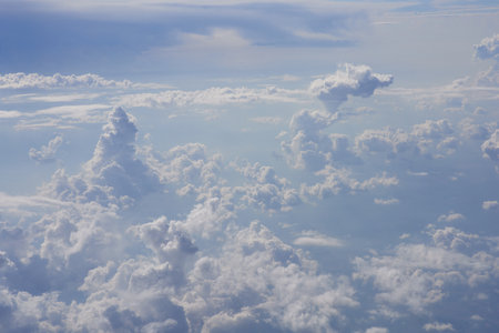 Clouds and sky as seen through window of an aircraft, view from aboveの写真素材