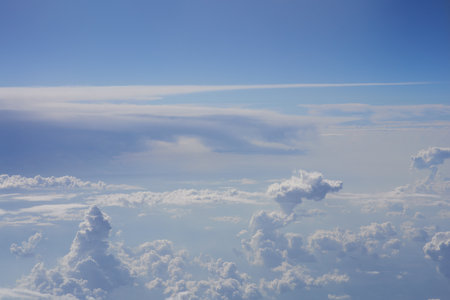Blue sky and white clouds. View from airplane window. Nature backgroundの写真素材