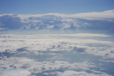 Clouds and sky as seen through window of an aircraft during flightの写真素材