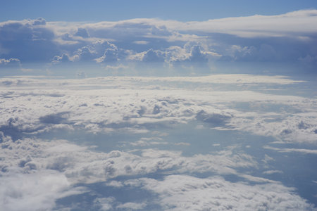 Clouds and sky as seen through window of an aircraft, view from aboveの写真素材