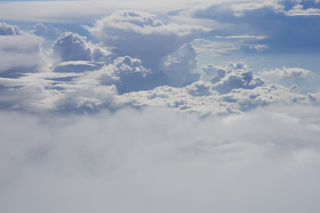 Clouds and sky as seen through window of an aircraft at high altitudeの写真素材