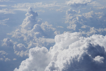 Clouds in the blue sky, view from an airplane window.の写真素材