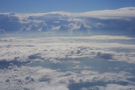Clouds and sky as seen through window of an aircraft, view from aboveの写真素材