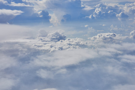 Clouds in the blue sky as seen through window of an aircraftの写真素材