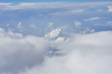 Clouds and sky as seen through window of an aircraft during flightの写真素材