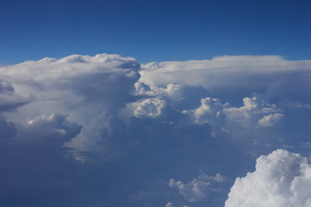 Blue sky background with white clouds. Cumulus clouds. White fluffy clouds in the blue sky.の写真素材