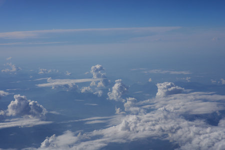 Clouds in the blue sky as seen through window of an aircraftの写真素材