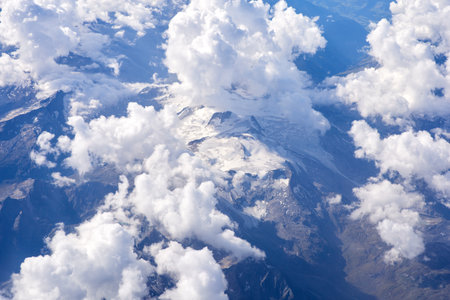 Clouds in the blue sky as seen through window of an aircraftの写真素材