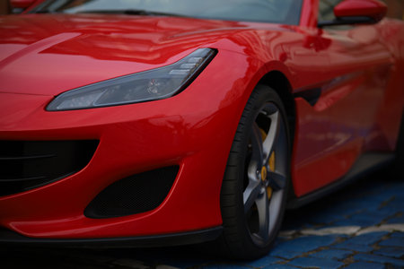 Close-up of a red sports car parked in the street.の写真素材