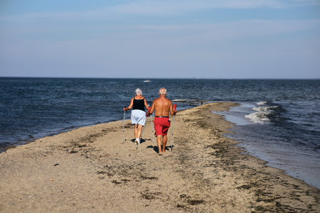 Senior couple jogging on the beach in summer. Healthy lifestyle.の写真素材