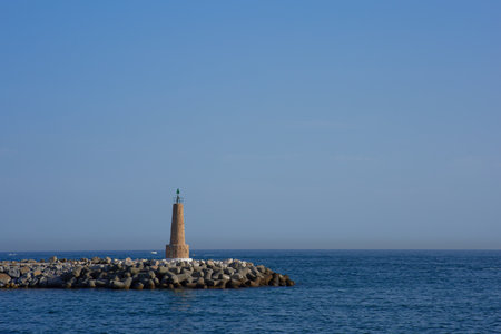 Lighthouse in the middle of the sea with blue sky background.の写真素材