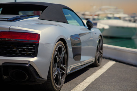 White sport car on the background of yachts in the portの写真素材