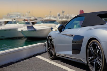 Luxury sports car on the background of yachts.の写真素材