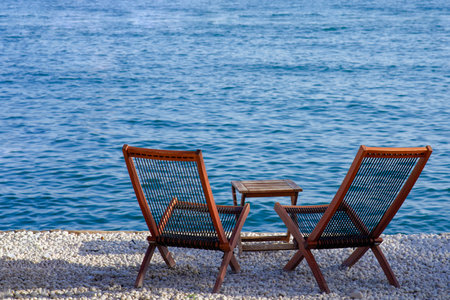Wooden chairs on the beach by the sea in a summer dayの写真素材
