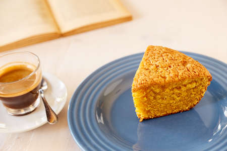 Homemade pie on a ceramic plate on a white wooden table. A piece of delicious carrot pie on a blue...