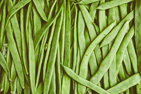 Organic natural imperfect vegetables with disabilities in a wicker basket on the market. Natural ecological green beans, legumes in the bazaar. Perfect background for a healthy organic foodの写真素材