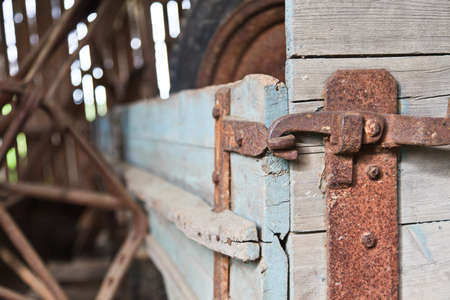 Old wagon with rusted metal locks in a barn