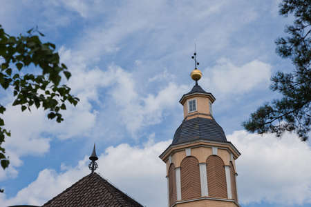 Old yellow chruch and blue skyの写真素材
