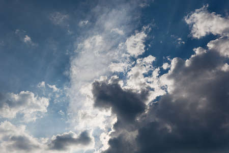 Dark clouds with rays of light shining throughの写真素材