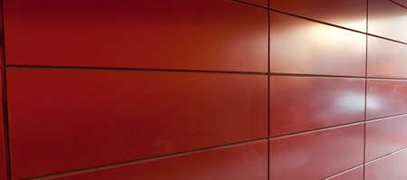 Red plate wall with reflections of light