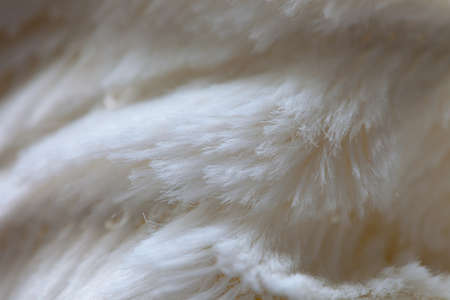 White colored fake fur blanket as waves on natural light