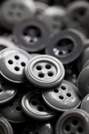 Pile of different kinds of gray textile buttonsの写真素材