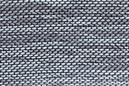 Furniture cover made of thick white and gray strings with thin blue strings
