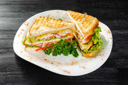 Sandwiches with chicken and Bacon. Black wooden backgroundの写真素材