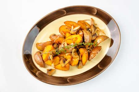 Fried potatoes with mushrooms on a white backgroundの写真素材