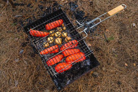 Vegetables and mushrooms fried in a grill on a grill.の写真素材