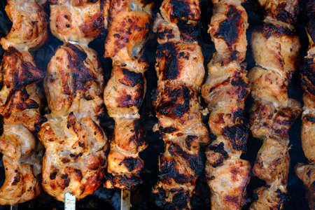 Preparation of shish kebab on outdoor charcoal grill.の写真素材