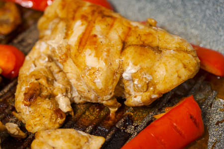 Grilled chicken breast slices with bell pepper.の写真素材