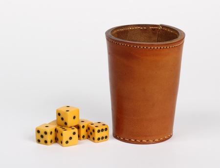 leather dice throwing cup and dice on whiteの写真素材