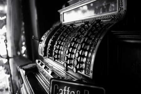 Black and white image of an old 19th century cash register. Selective focus on cashier buttons.の写真素材