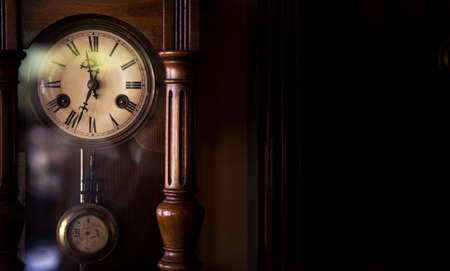 An old style wall clock from the 19th century. The clock is very old but in good condition and shows...