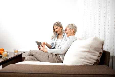 The senior blonde woman is very pleased because she has learned how to watch television online.