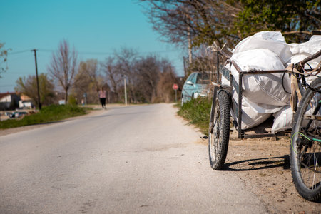 Tricycle for the transport of goods containing waste and secondary raw materials collected by landfills and ready for recycling.の写真素材