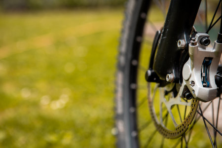 Close-up of a mountain bike brake system. See worn brake disc and hydraulic brake mechanism.の写真素材