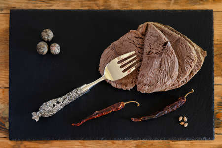 Boiled meat with dried pepper on a plateの写真素材