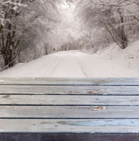 Empty wooden deck table with winter backgroundの写真素材